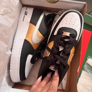Nike Kids Black, White, and Gold Sneakers